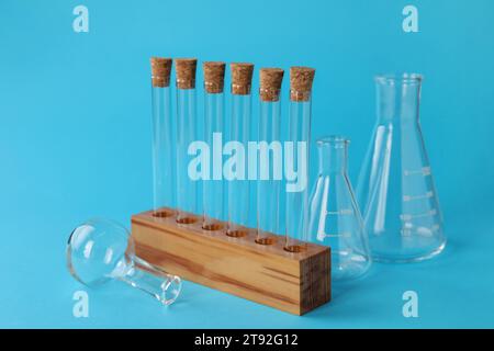 Different laboratory glassware with light blue liquid isolated on white ...