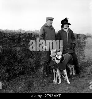 Hare Coursing UK 2000s. Cliff Standing and daughter Caroline trainer and owner with their greyhounds wait for a signal to walk their hounds down to the starting position during the Greyhound 2000 Meet. Near Six Mile Bottom, Newmarket, Suffolk 2000 England HOMER SYKES Stock Photo