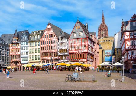 The Römerberg square in the old town of Frankfurt, lined with sidewalk cafes and half-timbered houses, overlooked by the steeple of the cathedral. Stock Photo