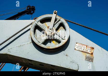 Close up of pulley wheel on old vintage equipment excavator England UK United Kingdom GB Great Britain Stock Photo