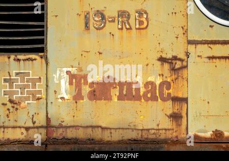 Close up of rusty rusting vintage Tarmac logo sign on old industrial construction vehicle England UK United Kingdom GB Great Britain Stock Photo