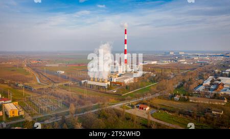 Above view on industrial landscape, thermal power plant with smokestack and cooling towers. White smoke is coming out from chimney in production proce Stock Photo