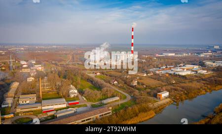 Above view on industrial landscape, thermal power plant with smokestack and cooling towers. White smoke is coming out from chimney in production proce Stock Photo