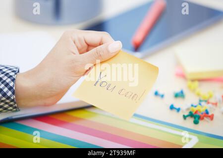 Human hand holding adhesive note with You can text Stock Photo