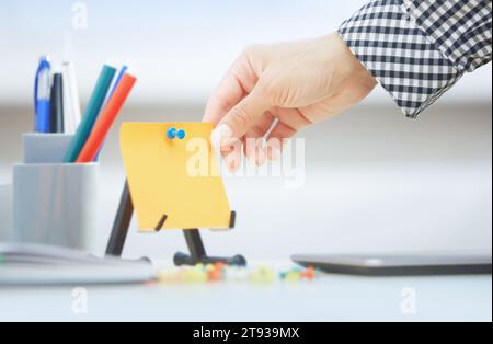 Human hand holding adhesive note with empty space Stock Photo