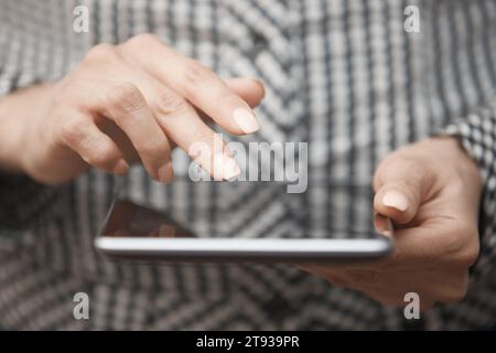 Hands of woman using digital tablet Stock Photo