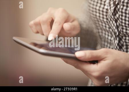 Hands of woman using digital tablet Stock Photo
