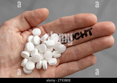 November 22, 2023: Hand full of tablets and the word Addiction on the fingers. Symbolic image tablet addiction PHOTOMONTAGE *** Hand voller Tabletten und dem Schriftzug Sucht auf den Fingern. Symbolbild Tablettensucht FOTOMONTAGE Credit: Imago/Ģ����ý Live News Stock Photo