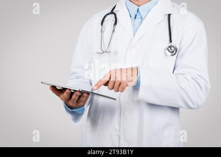 Doctor man using digital tablet, close-up view Stock Photo