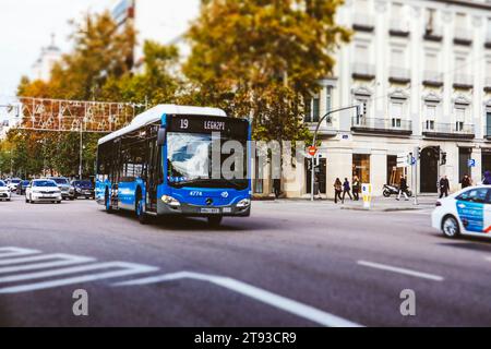 Spain, Madrid. November 19, 2023 Public transportation traffic, blue bus number 19 Legazpi, white cab moving on a road City traffic. Movement of trans Stock Photo