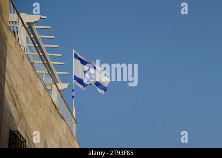 Flag of the State of Israel with the six-pointed Star of David on a blue sky background. Stock Photo