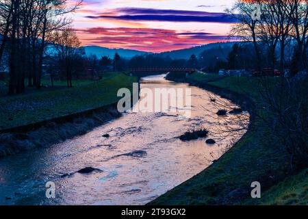 Beautiful spring landscape with river Ropa and forest at sunset, Gorlice, Poland. Stock Photo