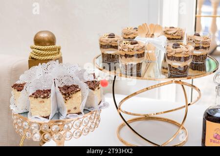 Decoration of a candy bar with various sweets at a festive event, desserts on the table. Stock Photo