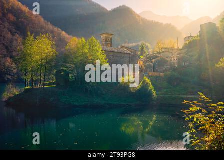 Isola Santa medieval village, lake and Alpi Apuane mountains in autumn foliage. Garfagnana, Tuscany region, Italy, Europe Stock Photo