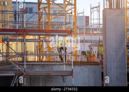 Construction workers working on a large building site Stock Photo