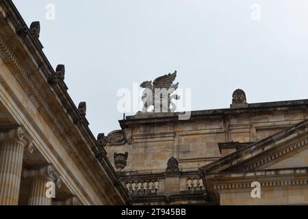 An ancient gargoyle at the top of national capitol building at downtown city Stock Photo