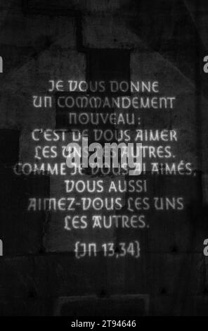 Light projection of bible verse Gospel of John 13:34  “A new command I give you: Love one another. As I have loved you, so you must love one another.' Stock Photo