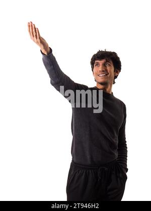 A handsome young man in a black sweater pointing at something, isolated on white Stock Photo