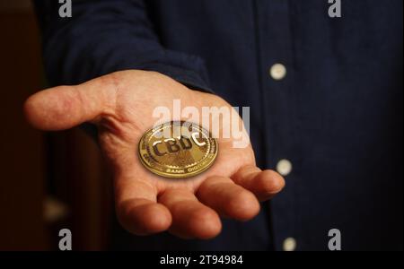 CBDC Digital Currency cryptocurrency golden coin in hand abstract concept Stock Photo