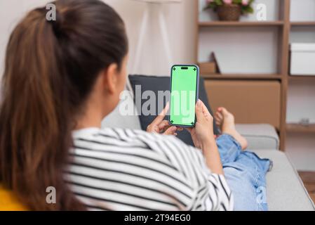 woman at home holding smartphone with chroma key, health appointment with doctor via an online call Stock Photo