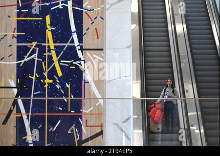 New York, USA. 22nd Nov, 2023. A traveler holds her suitcase as she descends an escalator at LaGuardia Airport in the Queens borough of New York City, NY, November 22, 2023. The day before Thanksgiving is expected to be one of the busiest travel days of the year. (Photo by Anthony Behar/Sipa USA) Credit: Sipa USA/Alamy Live News Stock Photo