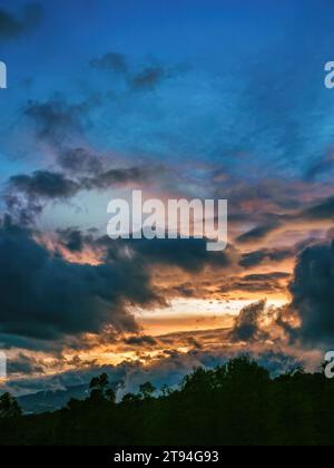 The beautiful colors of the afterglow and different kinds of clouds, in the sunset over the eastern Andean mountains of central Colombia. Stock Photo