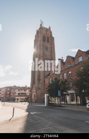 Memorial representing soldiers killed during World War II in Dunkirk France with rays of sunshine. The tall gothic tower in the center of the city. Stock Photo