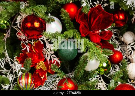 Close up of balls on Christmas tree. Christmas holiday decorations with balls, lights and garland on Christmas tree background. Holiday home decoratio Stock Photo