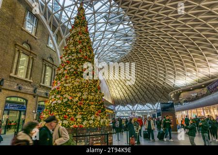 Christmas tree on the concourse at King's Cross station, London. Stock Photo