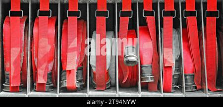 red fire hoses of firefighters placed inside the fire truck Stock Photo