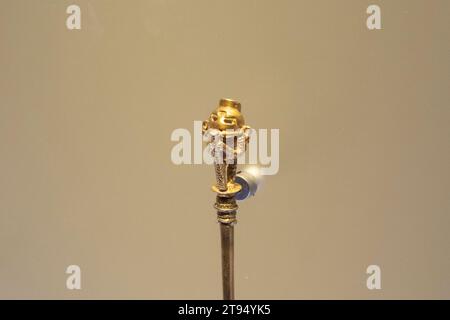 Indigenous golden small figure of a chaman playing flute Stock Photo