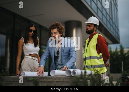 International Team of Architects Collaborating on Innovative Construction Project at Outdoor Workshop Stock Photo