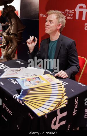 Paris, France. 22nd Nov, 2023. Canadian comic strip artist Marc Delafontaine, aka Delaf, signs a few copies of the new comic strip entitled 'Le Retour de Lagaffe' (The Return Of Gaston Lagaffe) at FNAC Ternes in Paris on 22 November 2023. Gaston Lagaffe, the comic strip hero who hasn't appeared in print since 1999, will be back in bookshops on 22 November 2023 with a new artist, the Canadian Delaf, whose loyalty to Franquin has been hailed by the critics. Photo by David Boyer/ABACAPRESS.COM Credit: Abaca Press/Alamy Live News Stock Photo