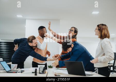 Multiracial, cross-generational team showcases successful career strategies in digital marketing through successful teamwork late at night. Stock Photo