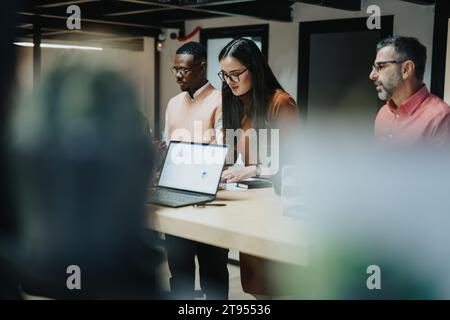 Late Night Collaboration. Business Team Analyzing Reports and Discussing Strategies. Stock Photo