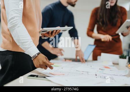 Successful Collaboration of Multiracial Colleagues at a Creative Office Working on Business Strategies and Analyzing Reports Stock Photo