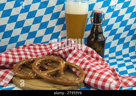 Bavarian pretzel, beer bottle and glass, Oktoberfest in Munich, Germany, Bavaria, Muenchen Stock Photo