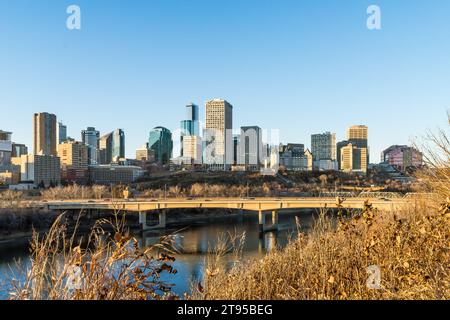 Edmonton, Canada, November 10, 2023: View to downtown in fall season in low sun light with deep shadows and bright wam highlights with blue sky Stock Photo