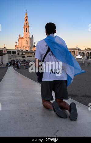 People walking the Penitential Path on knees towards the Chapel of the Apparitions. Sanctuary of Our Lady of the Rosary of Fátima in Fátima, Portugal. Stock Photo