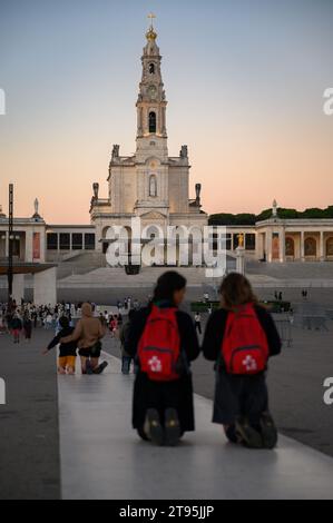 People walking the Penitential Path on knees towards the Chapel of the Apparitions. Sanctuary of Our Lady of the Rosary of Fátima in Fátima, Portugal. Stock Photo