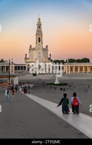 People walking the Penitential Path on knees towards the Chapel of the Apparitions. Sanctuary of Our Lady of the Rosary of Fátima in Fátima, Portugal. Stock Photo