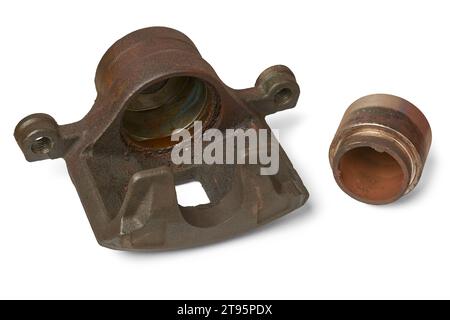 old disc brake caliper and piston, rusty and worn out components in the car hydraulic braking system, regular inspection and maintenance of braking Stock Photo