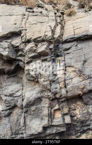 Hammer used as a reference on sedimentary rocks Stock Photo