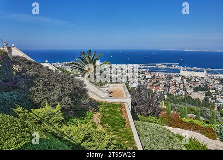 Haifa, Israel - October 22, 2023: Panorama of the Bahai Gardens and residential area with the seaport in the background from blue sky with clouds. Stock Photo