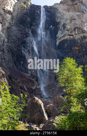 Famous Bridal Veil Fall or Waterfall Vertical Portrait, Low Autumn Water Flow, Granite Rock Cliff. Yosemite National Park, Sierra Nevada California US Stock Photo