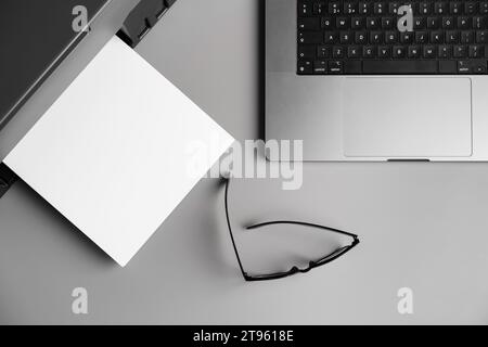 Printer and laptop on grey table in office Stock Photo