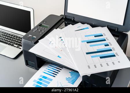 Printer and laptop on grey table in office Stock Photo