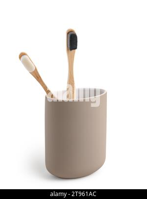 Bamboo tooth brushes in holder on white background Stock Photo - Alamy