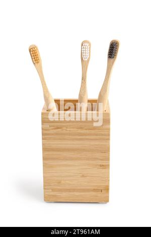 Bamboo tooth brushes in holder on white background Stock Photo - Alamy