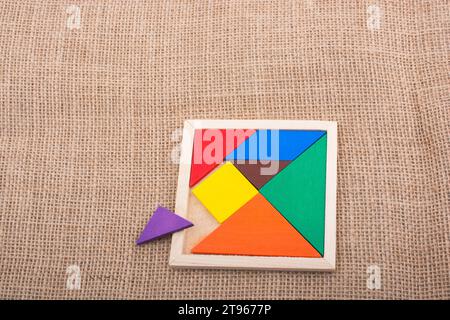 Colorful pieces of a square tangram puzzle Stock Photo